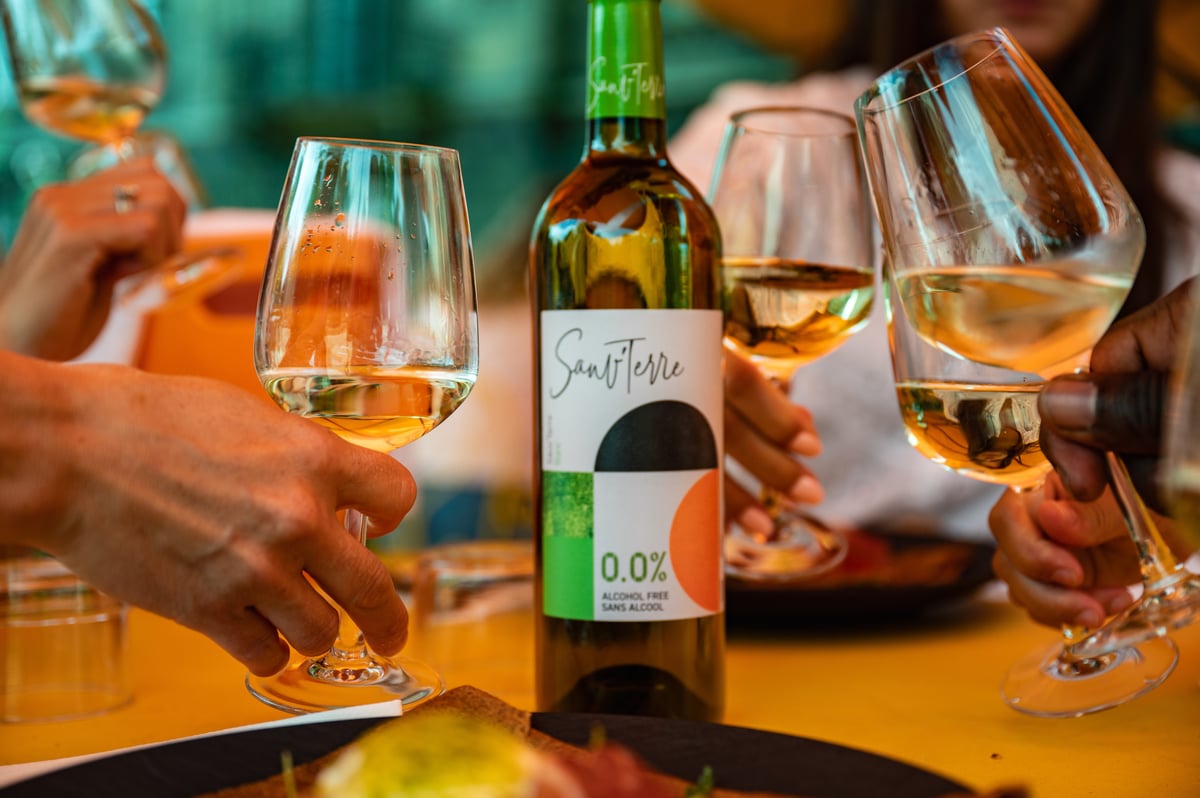 Alkoholfreier Weißwein umringt von Gläsern